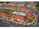 Community aerial view featuring swimming pool, lush landscaping, colorful buildings and ample parking space at 979 Park Terrace Cir, Kissimmee, FL 34746