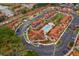 A bird's eye view features a community pool surrounded by vibrant residential buildings and parking areas at 979 Park Terrace Cir, Kissimmee, FL 34746