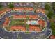 Stunning aerial view of a vibrant condo community featuring a central pool, lush landscaping, and ample parking at 979 Park Terrace Cir, Kissimmee, FL 34746