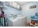 Functional laundry room with appliances, wire shelving for storage, and a clean organized appearance at 979 Park Terrace Cir, Kissimmee, FL 34746