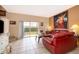 Cozy living room with comfortable seating, large art, and sliding doors leading to a private patio at 979 Park Terrace Cir, Kissimmee, FL 34746