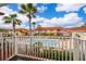 Community pool view surrounded by lush landscaping and well-maintained condos in a tropical setting at 979 Park Terrace Cir, Kissimmee, FL 34746