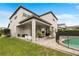 Spacious backyard with a covered patio, outdoor seating, and a sparkling pool at 9870 Summerlake Groves St, Winter Garden, FL 34787