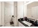Bathroom featuring a vanity with a black countertop, an undermount sink and white cabinets at 9870 Summerlake Groves St, Winter Garden, FL 34787