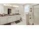 Primary bath boasts double vanity, a soaking tub with tiled surround, and a glass-enclosed shower at 9870 Summerlake Groves St, Winter Garden, FL 34787