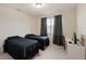 Bright bedroom featuring two twin beds, a window, and a desk at 9870 Summerlake Groves St, Winter Garden, FL 34787