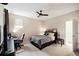 Bedroom with ceiling fan, and a dedicated workspace featuring a large black desk and an ergonomic chair at 9870 Summerlake Groves St, Winter Garden, FL 34787