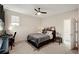 Spacious bedroom boasts a ceiling fan and a convenient workstation with a black desk and ergonomic chair at 9870 Summerlake Groves St, Winter Garden, FL 34787