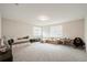 Spacious bonus room with a daybed, sofa, keyboard and plenty of natural light at 9870 Summerlake Groves St, Winter Garden, FL 34787
