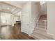 Inviting entryway with hardwood floors, staircase with baby gate, and views into the formal living spaces at 9870 Summerlake Groves St, Winter Garden, FL 34787
