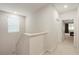 Upstairs hallway featuring neutral carpeting, a window for natural light, and access to the bedrooms at 9870 Summerlake Groves St, Winter Garden, FL 34787