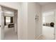 Hallway with a view into the main bedroom, featuring carpet and white walls at 9870 Summerlake Groves St, Winter Garden, FL 34787