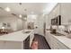Modern kitchen with white cabinets, stainless steel appliances, and a center island at 9870 Summerlake Groves St, Winter Garden, FL 34787