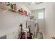 Functional laundry room with a washer, dryer, storage shelves, and natural light at 9870 Summerlake Groves St, Winter Garden, FL 34787