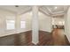 Bright living room featuring gleaming wood floors, columns, and large windows at 9870 Summerlake Groves St, Winter Garden, FL 34787