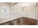 Bright living room featuring gleaming wood floors, large windows, and a modern chandelier at 9870 Summerlake Groves St, Winter Garden, FL 34787
