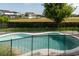 Backyard view of pool, -safety fence, brick pavers, and lush landscaping at 9870 Summerlake Groves St, Winter Garden, FL 34787