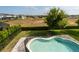 Backyard pool features -safety fence, brick pavers, green space, and views of neighborhood at 9870 Summerlake Groves St, Winter Garden, FL 34787