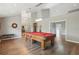 Spacious game room featuring a classic billiards table, hardwood floors, and elegant lighting fixtures at 9900 W Lake Marion Rd, Haines City, FL 33844