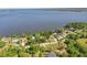 Stunning aerial view of lakeside homes with lush greenery and serene lake waters at 9900 W Lake Marion Rd, Haines City, FL 33844