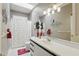 Bright bathroom features white cabinets, shower with polka dot curtain, and unique art at 9900 W Lake Marion Rd, Haines City, FL 33844