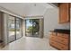 Dining area featuring large sliding doors with views of the pool and waterfront, complemented by wood cabinets at 9900 W Lake Marion Rd, Haines City, FL 33844