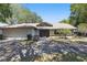 Charming single-story home with a two-car garage, front lawn, and inviting front door under blue skies at 9900 W Lake Marion Rd, Haines City, FL 33844