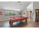 Spacious game room with hardwood floors and a pool table, perfect for entertaining guests at 9900 W Lake Marion Rd, Haines City, FL 33844