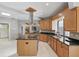 Well-equipped kitchen featuring wooden cabinets, black granite countertops, and stainless steel appliances at 9900 W Lake Marion Rd, Haines City, FL 33844