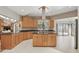 Spacious kitchen featuring light wood cabinets, dark countertops, a center island, and stainless steel vent hood at 9900 W Lake Marion Rd, Haines City, FL 33844