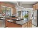 Well-equipped kitchen with stainless steel appliances, a center island with granite countertops, and waterfront views at 9900 W Lake Marion Rd, Haines City, FL 33844