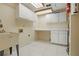 Laundry room with sink, white cabinets, tile flooring, overhead lighting, and workspace at 9900 W Lake Marion Rd, Haines City, FL 33844