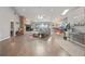 Spacious living room with hardwood floors, a stone fireplace, waterfront views, and ample natural light at 9900 W Lake Marion Rd, Haines City, FL 33844