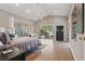 Large main bedroom with high ceilings, wood flooring, ceiling fan, large windows, and sliding glass door to the backyard at 9900 W Lake Marion Rd, Haines City, FL 33844