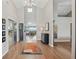 Bright foyer featuring hardwood floors, high ceilings, and an open floor plan with water view beyond the living room at 9900 W Lake Marion Rd, Haines City, FL 33844