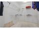 Walk-in closet with wire shelving units, carpet, and a wooden show stand at 9900 W Lake Marion Rd, Haines City, FL 33844