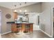 Breakfast bar with seating, granite countertop, and view into the kitchen area with modern appliances at 9900 W Lake Marion Rd, Haines City, FL 33844