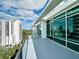 Relaxing balcony offers stunning city skyline views, surrounded by blue skies and modern glass at 101 S Eola Dr # 1209, Orlando, FL 32801