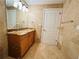 A well-lit bathroom features granite countertops and light brown tiling throughout at 101 S Eola Dr # 1209, Orlando, FL 32801