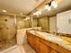 Lovely bathroom featuring a glass enclosed shower and double sink vanity with stunning countertops at 101 S Eola Dr # 1209, Orlando, FL 32801