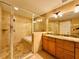 Beautiful bathroom with a glass enclosed shower and tub combo, and double sink vanity with stunning countertops at 101 S Eola Dr # 1209, Orlando, FL 32801