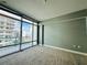 Large bedroom features views of the city through huge windows at 101 S Eola Dr # 1209, Orlando, FL 32801