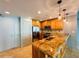 Galley kitchen featuring tan cabinets, stainless steel appliances and tan granite countertops at 101 S Eola Dr # 1209, Orlando, FL 32801