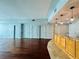 Open concept living space with hardwood floors, kitchen with wooden cabinets, and light blue walls at 101 S Eola Dr # 1209, Orlando, FL 32801