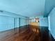 Open concept living space with hardwood floors, kitchen with wooden cabinets, and light blue walls at 101 S Eola Dr # 1209, Orlando, FL 32801