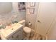 Bathroom featuring sink, toilet, tile flooring and nautical themed decorations at 103 Mason Park Dr, Daytona Beach, FL 32117