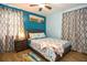 Bedroom featuring a full bed, wood-look flooring, and beach themed decorations at 103 Mason Park Dr, Daytona Beach, FL 32117