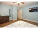 Bedroom featuring wood-look flooring, mirror and a flat screen TV at 103 Mason Park Dr, Daytona Beach, FL 32117