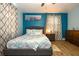 Cozy bedroom with a full bed, wood-look flooring, and beach themed decorations at 103 Mason Park Dr, Daytona Beach, FL 32117