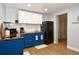 Kitchen with blue lower and white upper cabinets, and stainless-steel appliances at 103 Mason Park Dr, Daytona Beach, FL 32117